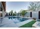 Inviting backyard pool with water feature, stylish fence, and manicured landscaping, perfect for outdoor relaxation at 8136 Canyon Grassland St, Las Vegas, NV 89166
