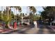View of the guarded entry gate to the community with lush palms and landscaping at 9000 Las Vegas Blvd # 1074, Las Vegas, NV 89123