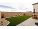 Large artificial turf backyard with seating area and block wall for added privacy at 9526 Granville Bridge St, Las Vegas, NV 89139