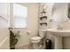 A half bathroom is decorated with neutral colors, and is equipped with a modern sink and toilet at 9526 Granville Bridge St, Las Vegas, NV 89139