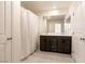 Bathroom featuring a double sink vanity with modern fixtures and a large mirror at 9526 Granville Bridge St, Las Vegas, NV 89139
