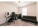 Well lit bedroom featuring carpet floors, desk, and modern futon at 9526 Granville Bridge St, Las Vegas, NV 89139