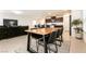 Open concept dining and living area featuring tile floors, a wood table and a comfortable sofa at 9526 Granville Bridge St, Las Vegas, NV 89139