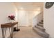 Inviting entryway with a stylish console table and access to the carpeted staircase at 9526 Granville Bridge St, Las Vegas, NV 89139