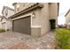 Spacious home featuring a two-car garage, desert landscaping, and a tiled walkway to the front door at 9526 Granville Bridge St, Las Vegas, NV 89139
