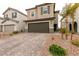 Attractive home with a well-maintained yard and a two-car garage on a paved driveway at 9526 Granville Bridge St, Las Vegas, NV 89139