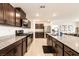 Spacious kitchen features granite countertops, stainless appliances, and dark wood cabinetry at 9526 Granville Bridge St, Las Vegas, NV 89139