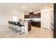 Spacious kitchen featuring a large island with seating, stainless steel appliances, and dark wood cabinets at 9526 Granville Bridge St, Las Vegas, NV 89139