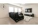 Comfortable living room with a plush sectional sofa, large windows, and contemporary decor at 9526 Granville Bridge St, Las Vegas, NV 89139
