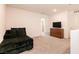 Open loft area with a comfortable lounge chair, dresser and TV at 9526 Granville Bridge St, Las Vegas, NV 89139
