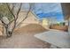 Spacious backyard with a concrete patio, gravel landscaping, and a block wall at 9732 Kampsville Ave, Las Vegas, NV 89148