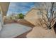 Large backyard featuring a concrete patio, gravel landscaping, and block wall for privacy at 9732 Kampsville Ave, Las Vegas, NV 89148