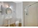 Bathroom featuring a glass shower enclosure, pedestal sink, toilet, and a tiled floor at 9732 Kampsville Ave, Las Vegas, NV 89148