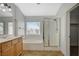Bathroom with double sinks, a soaking tub, and a glass shower enclosure at 9732 Kampsville Ave, Las Vegas, NV 89148