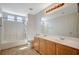 Bright bathroom featuring a double sink vanity, tile floors, and a shower-tub combination at 9732 Kampsville Ave, Las Vegas, NV 89148