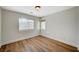 Bedroom featuring a large window and wood-look floors at 9732 Kampsville Ave, Las Vegas, NV 89148