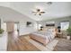 Virtually staged primary bedroom featuring vaulted ceiling, fan, and wood-look floors at 9732 Kampsville Ave, Las Vegas, NV 89148