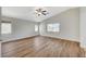 Vaulted ceiling bedroom with ceiling fan and wood-look floors at 9732 Kampsville Ave, Las Vegas, NV 89148