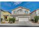 Inviting two-story home featuring a stucco facade, tile roof, and an attached two-car garage at 9732 Kampsville Ave, Las Vegas, NV 89148