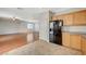 Kitchen area next to living room shows ample counter space, black refrigerator and view into the living room at 9732 Kampsville Ave, Las Vegas, NV 89148