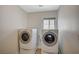 Well-equipped laundry room featuring a washer and dryer, with a window to brighten the space at 9732 Kampsville Ave, Las Vegas, NV 89148