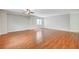 Spacious open living room featuring wood flooring and a ceiling fan for added comfort at 9732 Kampsville Ave, Las Vegas, NV 89148