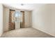 Vacant bedroom featuring neutral walls and carpet, with a window with curtains at 9908 Camino Loma Verde Ave, Las Vegas, NV 89117