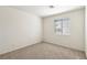 Neutral bedroom features carpeted floors and a window letting in natural light at 9908 Camino Loma Verde Ave, Las Vegas, NV 89117