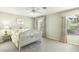 Bright bedroom featuring neutral walls, carpet, ceiling fan, and a large window with natural light at 9908 Camino Loma Verde Ave, Las Vegas, NV 89117