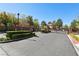 Gated neighborhood entrance features mature trees and landscaping at 9908 Camino Loma Verde Ave, Las Vegas, NV 89117