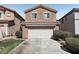 Two-story home featuring a large two car garage and low maintenance desert landscaping at 9908 Camino Loma Verde Ave, Las Vegas, NV 89117