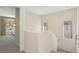 Light-filled upstairs hallway leads to other areas of the home at 9908 Camino Loma Verde Ave, Las Vegas, NV 89117