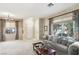 Bright living room with neutral decor, large windows, and an open floor plan at 9908 Camino Loma Verde Ave, Las Vegas, NV 89117