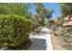 Community walkway features landscaping and mature trees at 9908 Camino Loma Verde Ave, Las Vegas, NV 89117