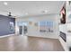 Open living space with hard surface flooring, big windows, and a fireplace at 3792 Calle De Rio Ave, Las Vegas, NV 89115