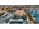 Overhead view showcases condos with tile roofs, covered parking, and well-manicured landscaping with city skyline views at 10001 Peace Way # 2269, Las Vegas, NV 89147