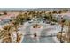 An aerial view of Chateau Nouveau's entrance, roundabout, mature landscaping, and gated entry at 10001 Peace Way # 2269, Las Vegas, NV 89147