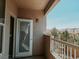 View of the balcony with a white sliding door and railing overlooking the neighborhood at 10001 Peace Way # 2269, Las Vegas, NV 89147