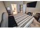 Comfortable bedroom with a serene ambiance, a large TV, and easy access to the en-suite bathroom at 10001 Peace Way # 2269, Las Vegas, NV 89147
