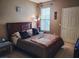 Bedroom features a queen sized bed, window with blinds, and a neutral color scheme at 10001 Peace Way # 2269, Las Vegas, NV 89147