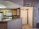 Efficient kitchen featuring wooden cabinetry, a functional layout, and seamless access to adjacent rooms at 10001 Peace Way # 2269, Las Vegas, NV 89147
