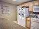 This view captures the kitchen, highlighting its cabinetry, granite-look countertops, and essential appliances at 10001 Peace Way # 2269, Las Vegas, NV 89147