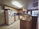Functional kitchen with wooden cabinets, white appliances, and a breakfast bar, ideal for casual dining at 10001 Peace Way # 2269, Las Vegas, NV 89147
