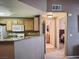 Efficient kitchen featuring wooden cabinetry, a functional layout, and seamless access to adjacent rooms at 10001 Peace Way # 2269, Las Vegas, NV 89147