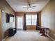 Bright, neutral living room with carpet, ceiling fan, door to balcony, large window and a table for multiple uses at 10001 Peace Way # 2269, Las Vegas, NV 89147