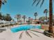 Community pool featuring clear blue water and palm trees at 10001 Peace Way # 2269, Las Vegas, NV 89147