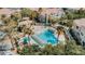 Aerial view of a community pool surrounded by palm trees and residential buildings at 10001 Peace Way # 2269, Las Vegas, NV 89147