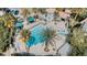 Overhead view of a sparkling community pool with palm trees and covered seating areas at 10001 Peace Way # 2269, Las Vegas, NV 89147