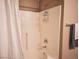 Bathroom shower with white tile, shower head, and mounted caddy for soaps and shampoos at 10001 Peace Way # 2269, Las Vegas, NV 89147