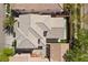 An aerial view of a well-maintained home with a neat gray tiled roof and a well-kept artificial grass backyard at 10505 Howling Coyote Ave, Las Vegas, NV 89135